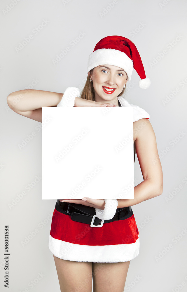 Girl in Christmas costume with blank square white banner Girl in Christmas costume with blank square white banner