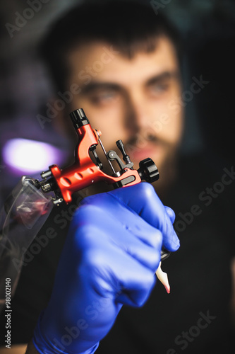 Tattooist makes a tattoo. Closeup