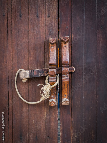 Brown wooden door and wooden lock