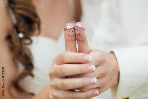 wedding rings on her fingers painted with the bride and groom, funny little men