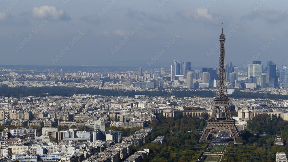 Aerial view, from Montparnasse tower, with Eiffel tower and La Defense district in Paris, France. Aerial view, from Montparnasse tower, with Eiffel tower and La Defense district in Paris, France.