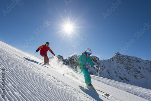 downhill skiing in behind the sun