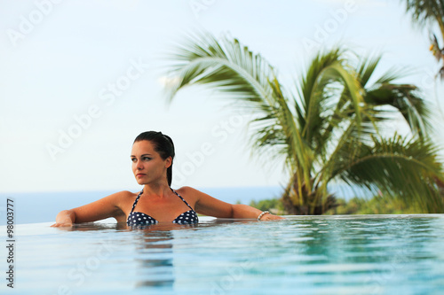 woman relaxing at infinity swimming pool © Vladimir Badaev