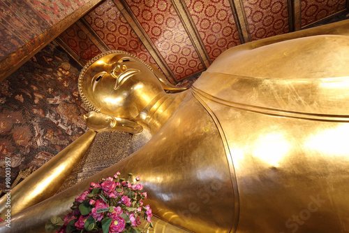 reclining buddha gold statue face at wat pho in bangkok