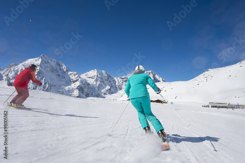 Skiing on skirun in the alps - prepared piste and sunny day