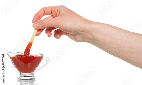 Foto French fry being dipped in ketchup