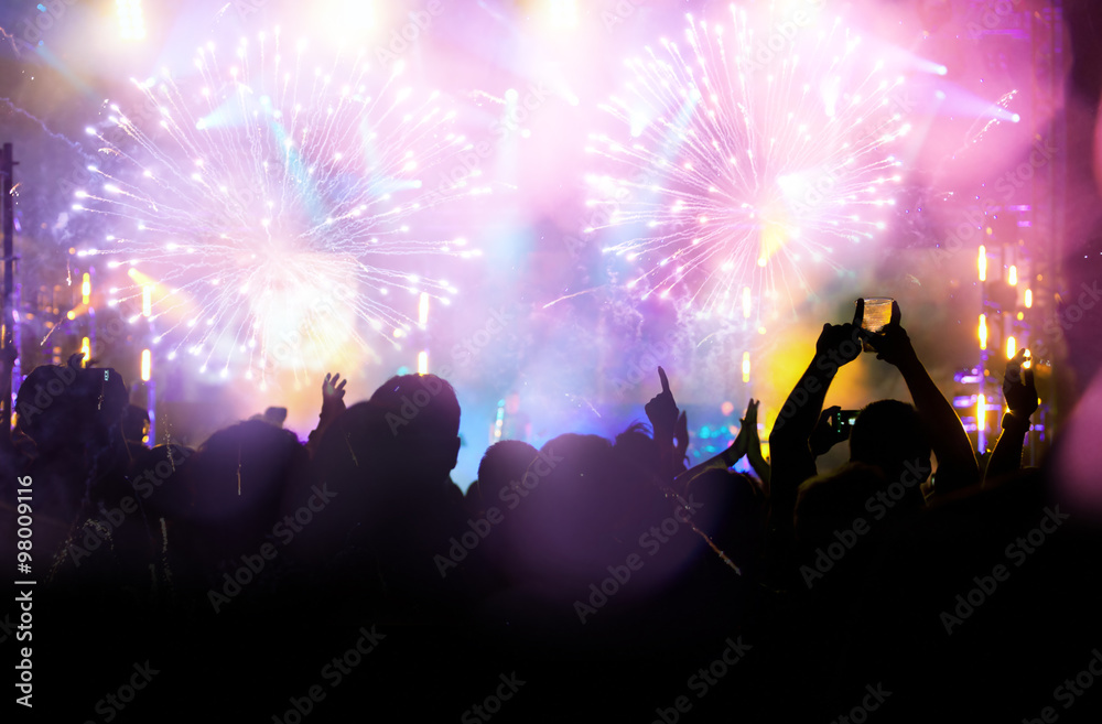 New Year concept - cheering crowd and fireworks
