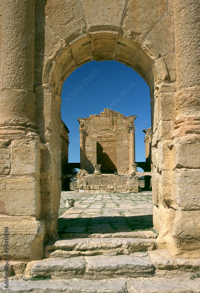 Tunisia. Ancient Sufetula (present day Sbeitla). Entrance to the forum via the triumphal arch. View of one from three temples forming the capitolium