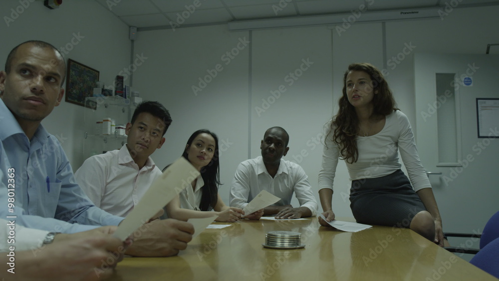 Female manager presents to company staff. Office employees at work in modern building. Casual business people discussing projects in product manufacturing company. Female manager presents to company staff. Office employees at work in modern building. Casual business people discussing projects in product manufacturing company.