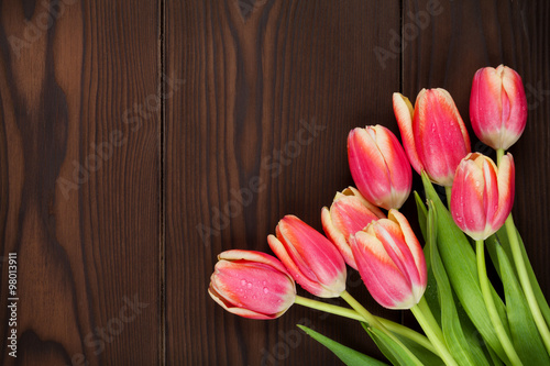 Colorful tulips over wooden table