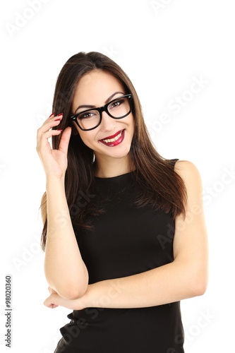 Young brunette woman in black dress on a white background