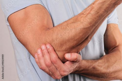 Canvas Print Man With Pain In Elbow. Pain relief concept