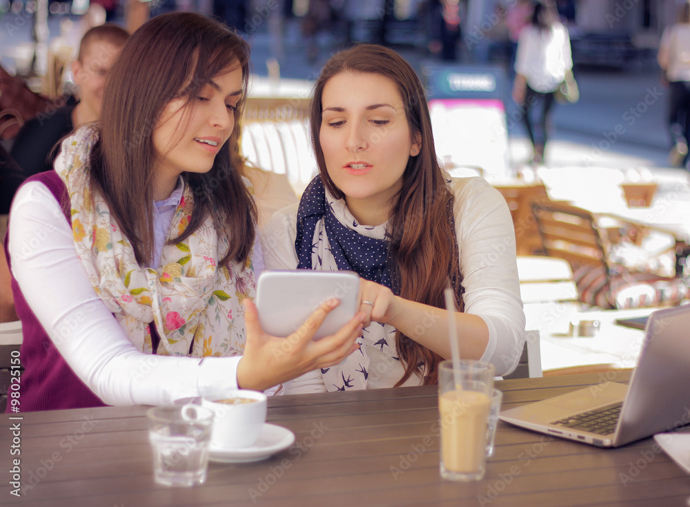 Two Beautiful Females In Cafe Using Digital Tablet Two Beautiful Females In Cafe Using Digital Tablet