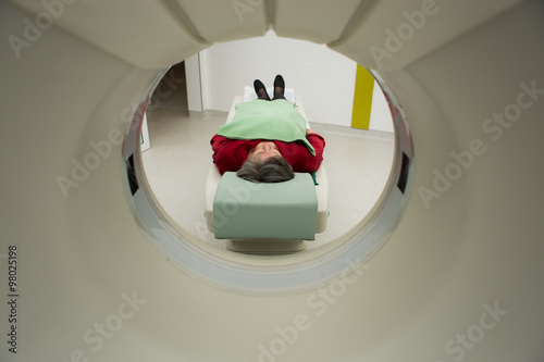 Modern medical equipment, preventional medicine and healthcare.Computer tomography scan.Old woman patient at computerized axial tomography (CAT) scan.Examining cancer patient with CT.Tumor detection photo