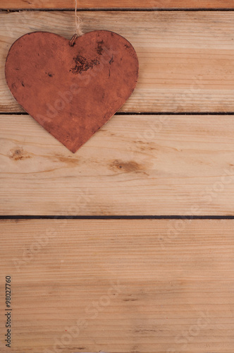 Metal heart on the wooden table