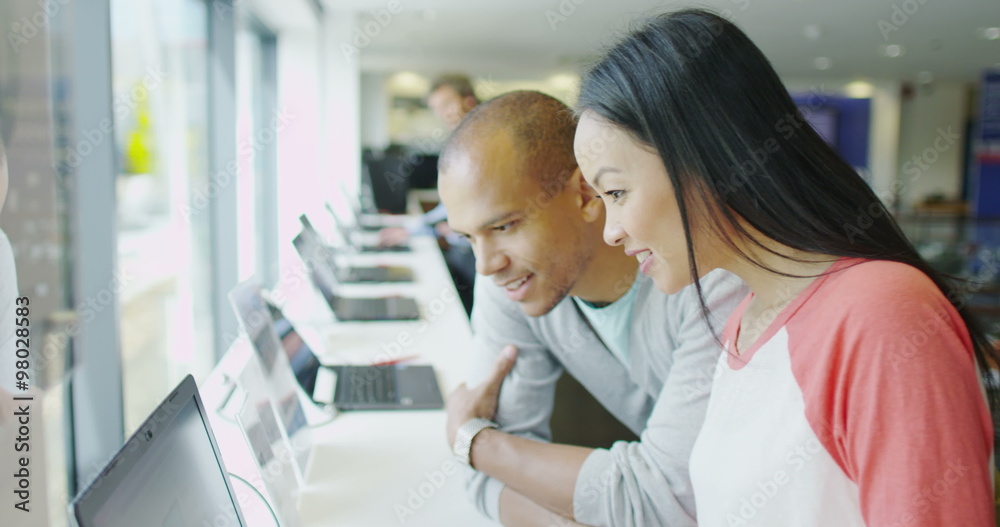Couple shopping in consumer electronics store showroom
