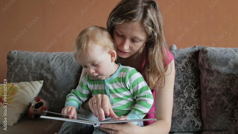 Mother is reading book for her son Mother is reading book for her son