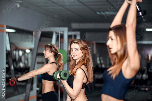 Three young girls workout in the gym