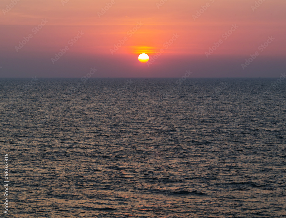 Horizontal vivid vibrant dramatic sunset in Indian ocean backgro