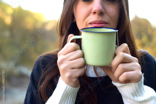 Woman drinking a hot Drink in a cold Weather