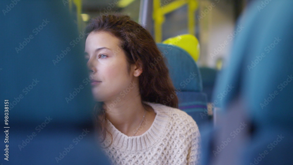 young female using her digital tablet on a moving train