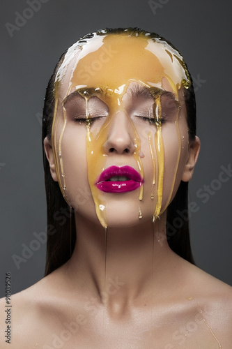 woman with a honey on her face and pink lips