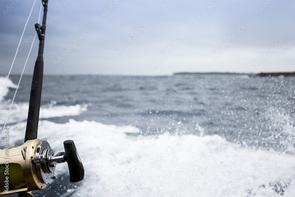 Fishing rod above the splashes of the sea Fishing rod above the splashes of the sea