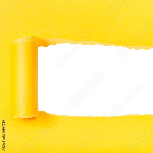 yellow rolled-up torn paper on square background photo