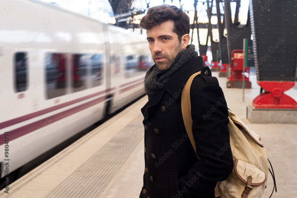 Obraz premium Young man waits for train in station