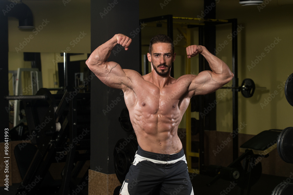 Bodybuilder Performing Rear Double Biceps Pose Bodybuilder Performing Rear Double Biceps Pose