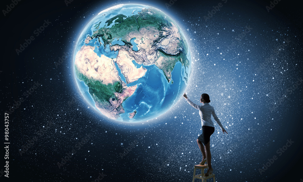 Businesswoman reaching Earth planet 