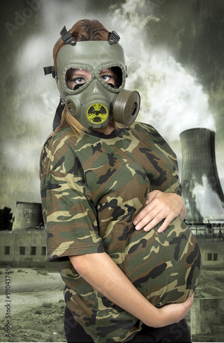 Portrait of 9 months pregnant woman in gas-mask