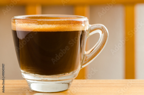 Cup of hot coffee (espresso) on wooden background