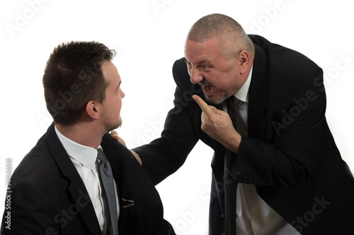 Businessman screaming and fighting at a young colleague