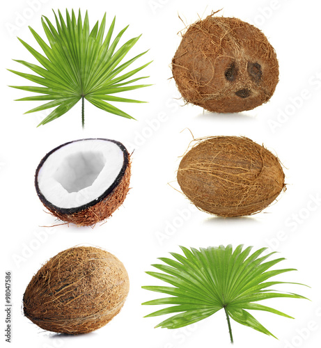 Fresh coconuts with palm leaves, isolated on white