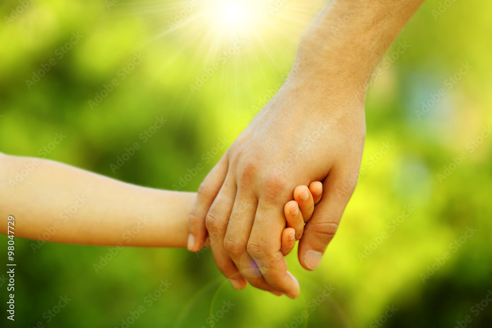 Hands of father and son holding each other Hands of father and son holding each other