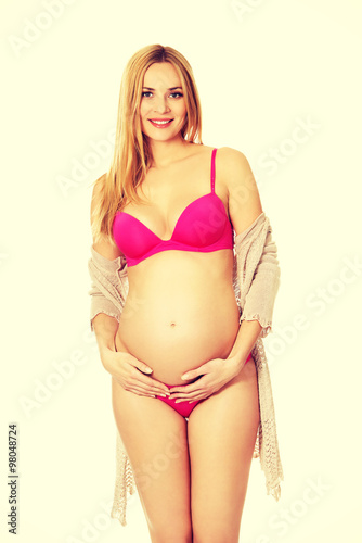 Pregnant woman in lingerie and cardigan © Piotr Marcinski