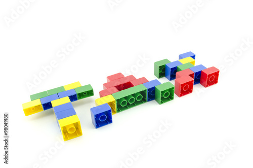 word TAX built from colorful building blocks isolated on white background