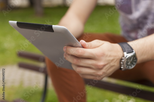 Man use tablet reading news and communicate on social networks