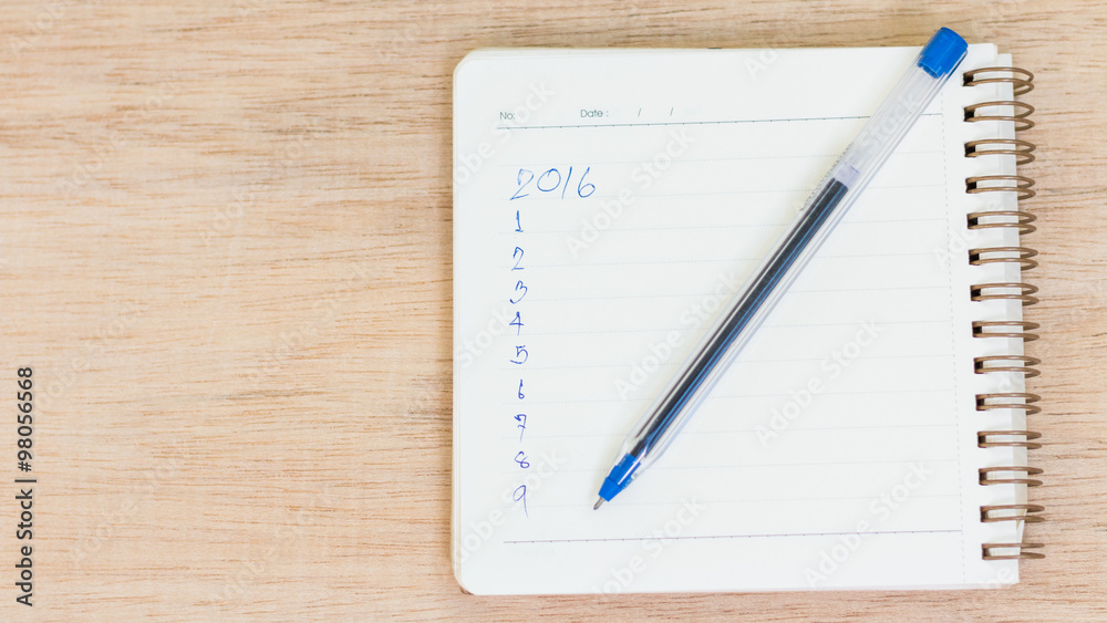 Goals for 2016 - checklist on notepad with pen on wooden backgro Goals for 2016 - checklist on notepad with pen on wooden backgro