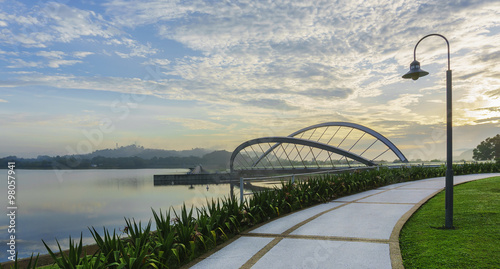 View of pedestrian walkway at Seri Empangan recreational park at Putrajaya during sunrise with modern design of bridge as background. photo