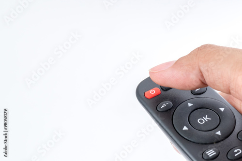Remote control in hand over white background with clipping path