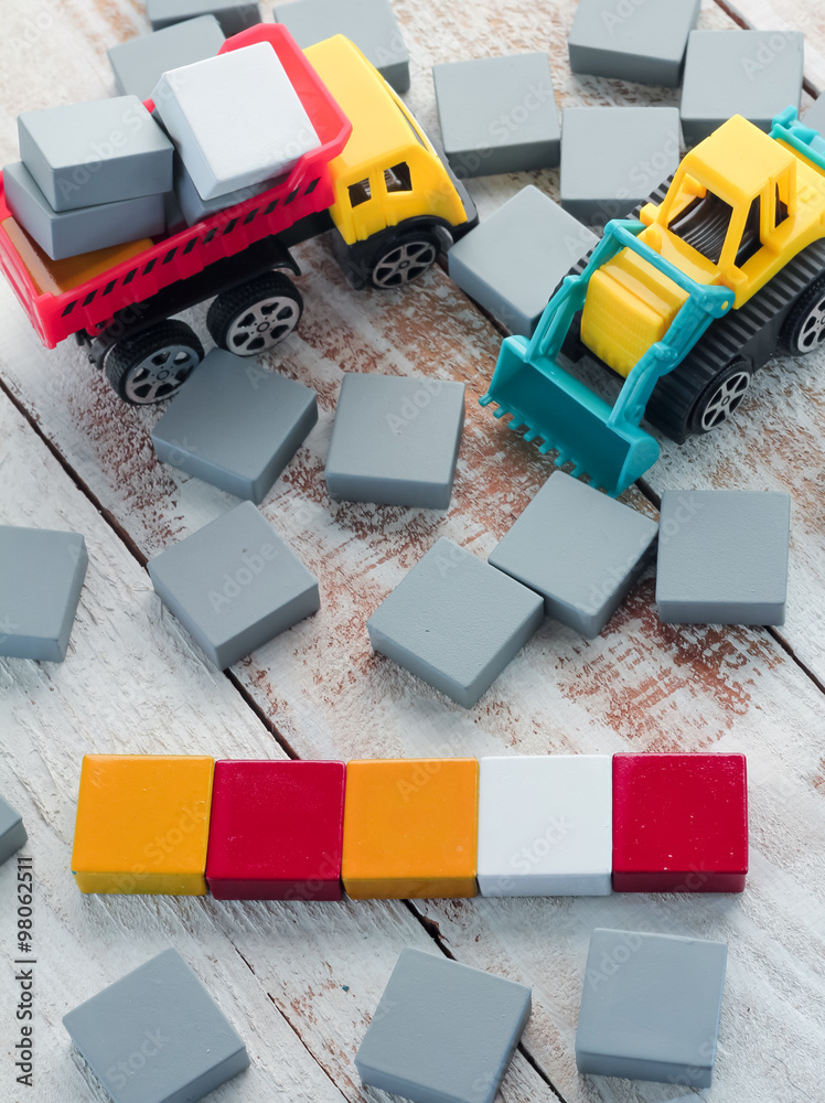 Obraz premium blank colorful Wood Scrabble Pieces with truck toys