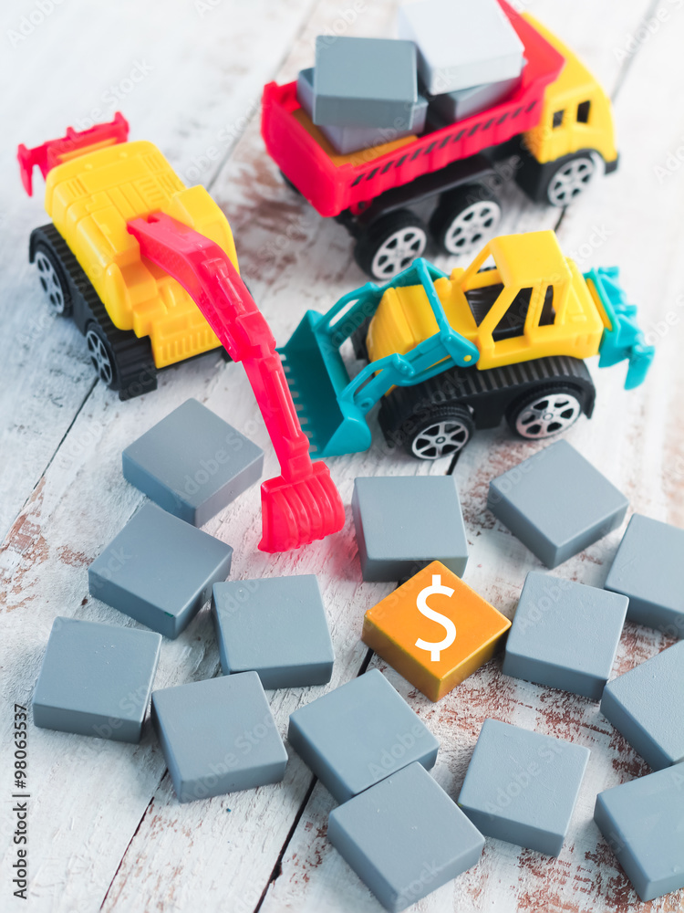 truck digging word block fill with money symbol business concept truck digging word block fill with money symbol business concept