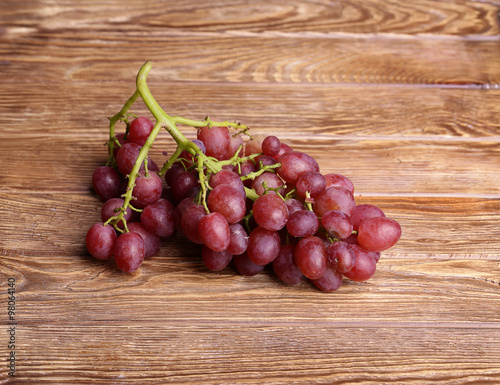 red grapes on wooden table background