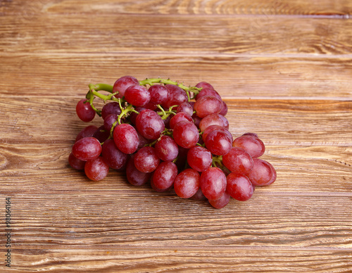 red grapes on wooden table background