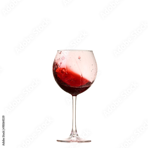 red wine glass on a white background, splash