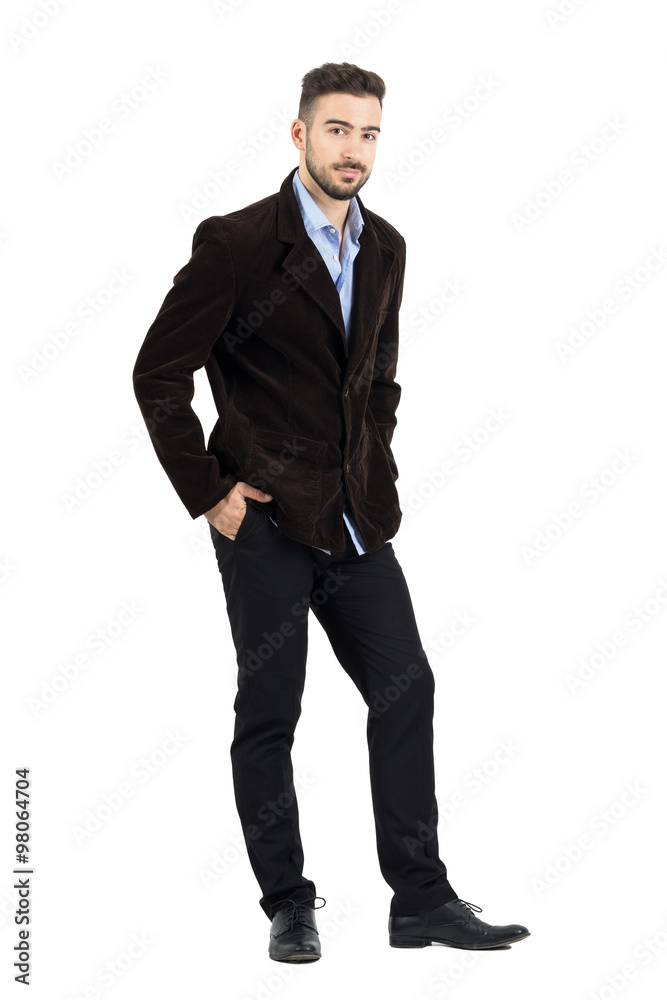 Smiling man in corduroy coat with hands in pocket looking at camera. Full body length portrait isolated over white studio background. Smiling man in corduroy coat with hands in pocket looking at camera. Full body length portrait isolated over white studio background.