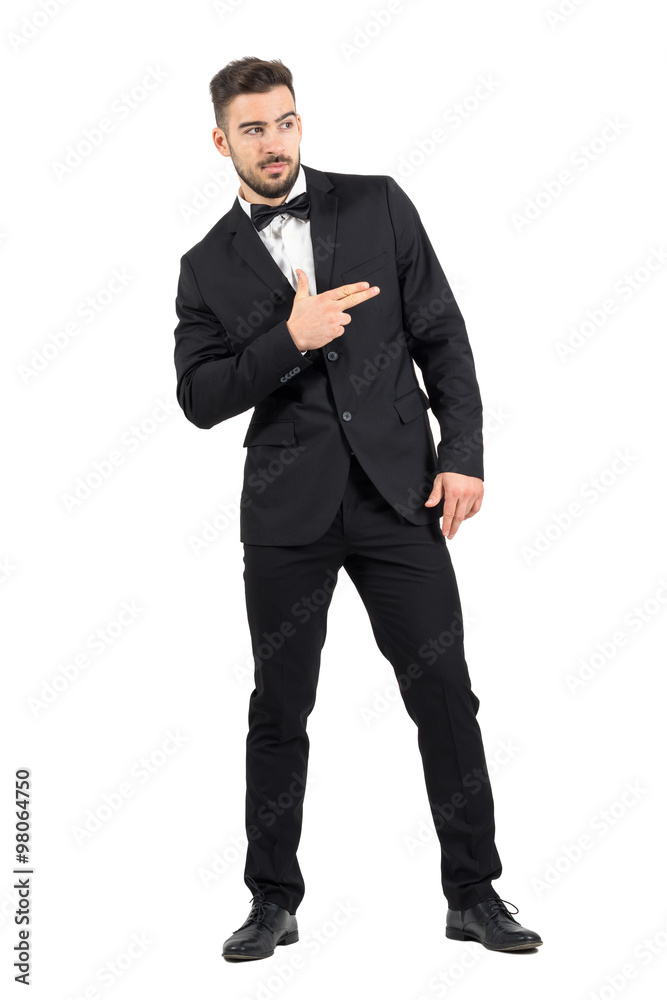 Funny secret agent with finger gun hand gesture looking away. Full body length portrait isolated over white studio background. Funny secret agent with finger gun hand gesture looking away. Full body length portrait isolated over white studio background.