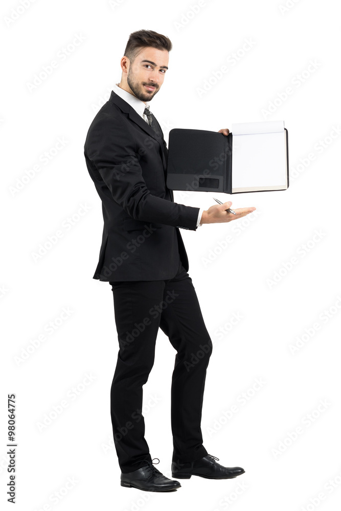 Salesman in suit showing blank empty document paper. Full body length portrait isolated over white studio background. Salesman in suit showing blank empty document paper. Full body length portrait isolated over white studio background.